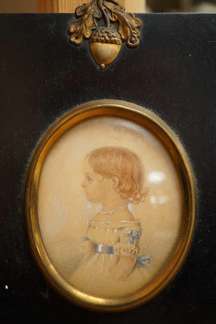 Regency School, Oval portrait miniature of a young girl in profile, watercolour on card, housed in an ebonised and gilt frame, overall 12 x 10cm